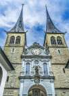 Church of St. Leodegar facade-Lucerne-Switzerland. St. Michael statue. Art Print